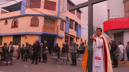 El padre José Caselli Sandoval sale a la calle con la cruz y se planta entre manifestantes agresivos y la policía antidisturbios y pese a los gases lacrimógenos, evitó más violencia